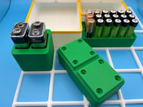 Gridfinity containers customized to hold AAA and D batteries.